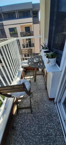 a balcony with a table and chairs on a building at Apartman Dejanović 1 in Veliko Gradište
