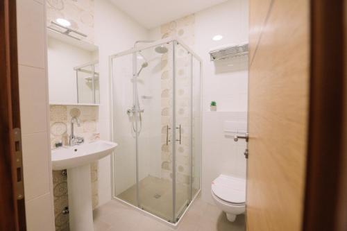 a bathroom with a shower and a toilet and a sink at Sobe B&M Livno in Livno