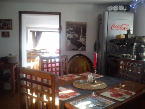 a kitchen with a table and chairs and a refrigerator at Willa Pod Aniołem - Pokoje Gościnne & Apartamenty z widokiem na góry in Szczyrk