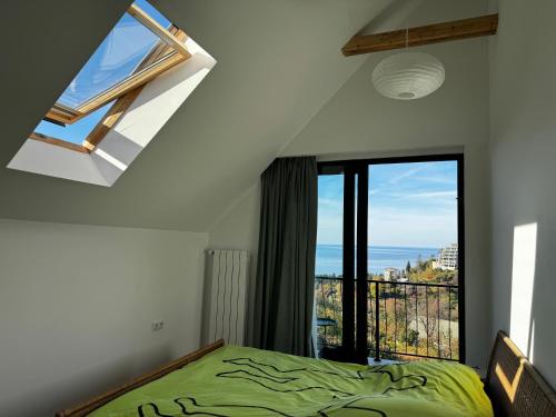 a bedroom with a bed and a large window at Sea View Private Villa in Batumi