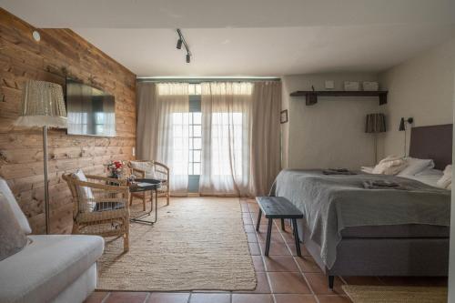 a bedroom with a bed and a table and a couch at Gumbalde Resort in Stånga