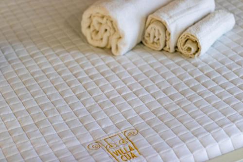 a close up of two white towels on a bed at Villa Cua in Ercolano
