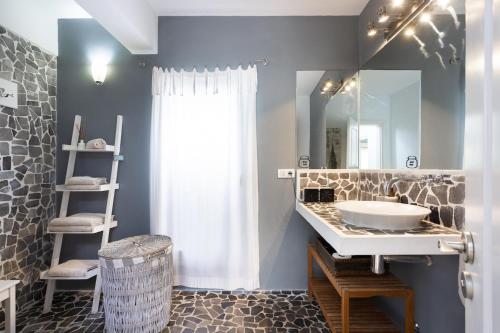a bathroom with a sink and a mirror at Views Spacious Villa in El Rincón