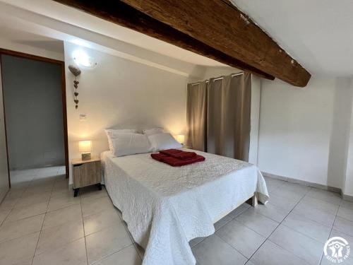 a bedroom with a bed with a red towel on it at Rafael in Quintillan