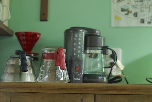 a counter with a coffee maker on it at PavilionSurf&Lodge in Shishikui