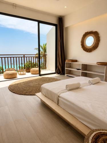 a bedroom with a large bed and a large window at Samura Panorama Guest House in Thulusdhoo