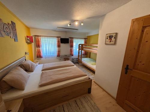 a bedroom with two beds and a bunk bed at Haus Falkner in Mutters