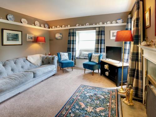 a living room with a couch and a television at Wanton Wa's in Edinburgh