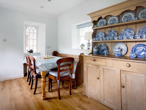 a kitchen with a table and blue dishes on the shelves at Wanton Wa's in Edinburgh