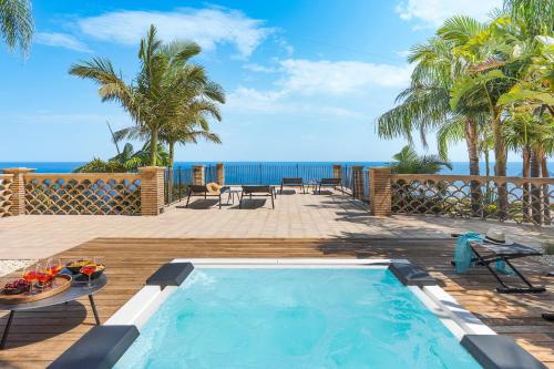 a swimming pool with a view of the ocean at Buena Vista in Letojanni