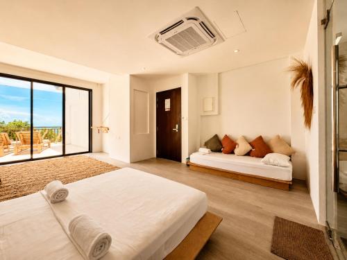 a large bedroom with two beds and a couch at Samura Panorama Guest House in Thulusdhoo