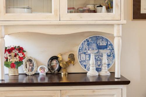 a shelf with plates and other items on it at Villa Aposperitis in Panormos Rethymno