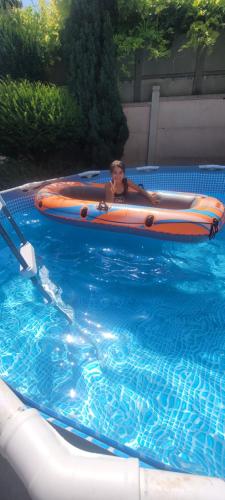a person in a raft in a swimming pool at CozyCube Paris in Vitry-sur-Seine