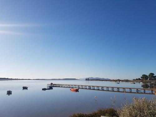 a dock on a lake with boats in the water at Appartamenti Elios in Birgi Vecchi