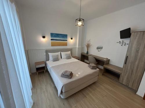 a bedroom with a bed and a tv in it at ILIOVASILEMA - Ηλιοβασίλεμα in Pefki