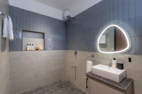 a bathroom with a sink and a mirror at Saffronstays Crimson Crest in Khopoli