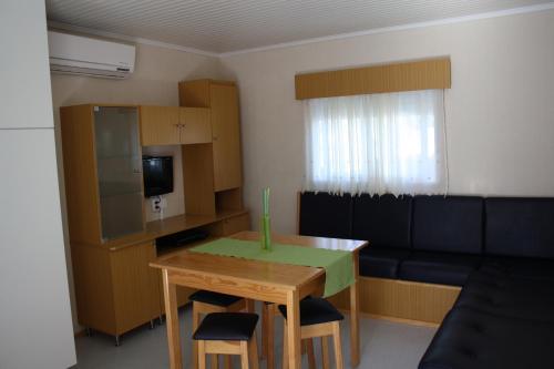 a small living room with a table and a couch at Valbom by Campigir in Sesimbra