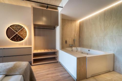 a bathroom with a tub in a room at NaturHotel Snovik in Kamnik
