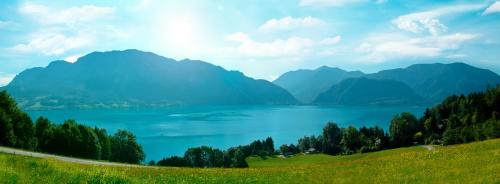 a view of a lake with mountains in the background at Hotel Stadler am Attersee in Unterach am Attersee