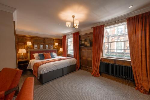 a bedroom with a bed and a window at Angel @ KingSt in Knutsford