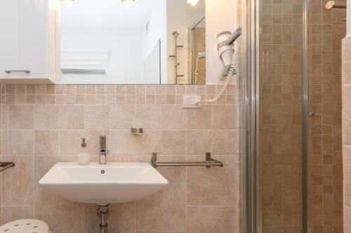 a bathroom with a sink and a shower at A 104 Puntavilla in La Maddalena