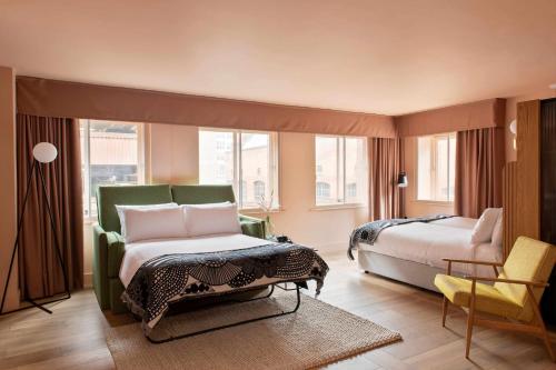 a hotel room with a bed and a chair at Whitworth Locke in Manchester