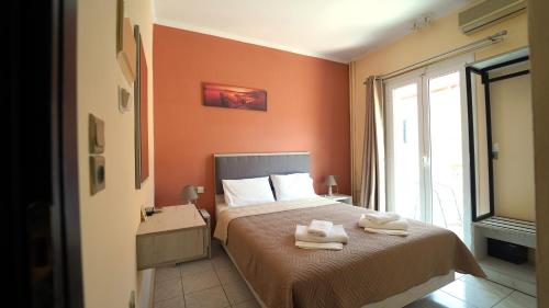 a bedroom with a bed with two towels on it at Oliva Resort View & Swimming pool Studios in Parga
