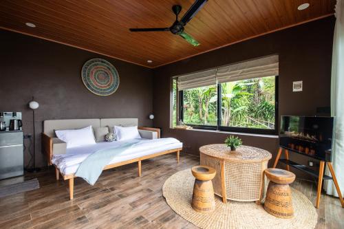a bedroom with a bed and a large window at Wanagiri Reserve in Gitgit