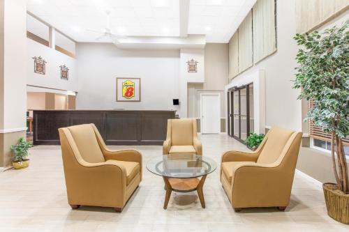 a lobby with two chairs and a glass table at Super 8 by Wyndham Oklahoma City in Oklahoma City