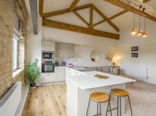 a kitchen with white cabinets and a white counter top at Heritage Serviced Suites - Serviced Apartments in Huddersfield