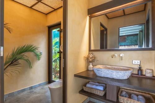 a bathroom with a sink and a mirror at Tanaw Villas in General Luna