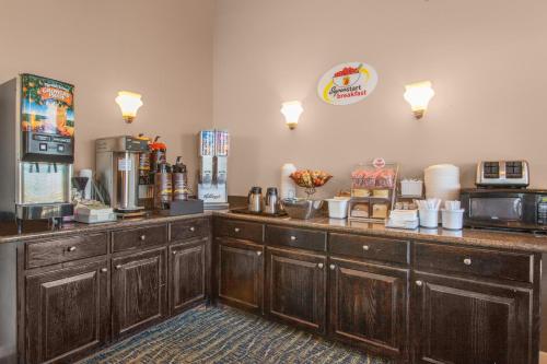 a coffee shop with wooden cabinets and a counter top at Super 8 by Wyndham Oklahoma City in Oklahoma City