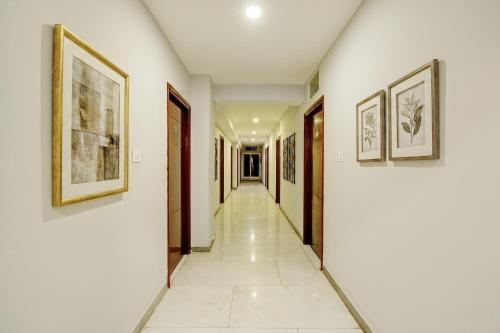 a corridor in a house with paintings on the walls at FabHotel Vaishnavi Classic in Secunderabad