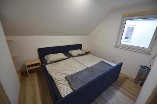 a small bed in a room with a window at Slovenia Valley Views in Lipa pri Frankolovem