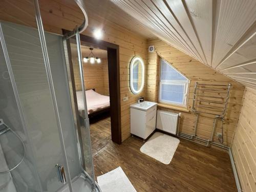 a small bathroom with a shower and a bedroom at Андріана in Mykulychyn