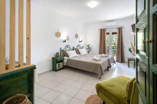 a bedroom with a bed and a table in a room at Pavlos Maria studios in Skiathos