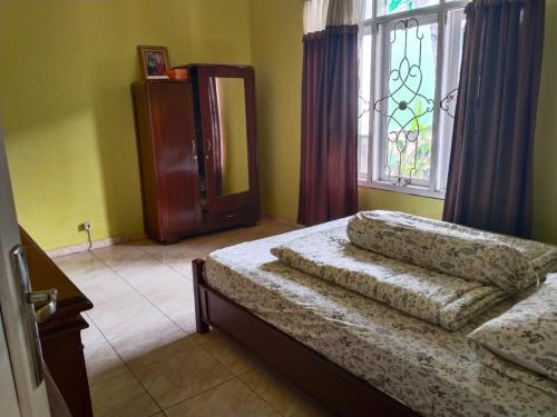 a bedroom with a bed and a window at Priv garut in Garut