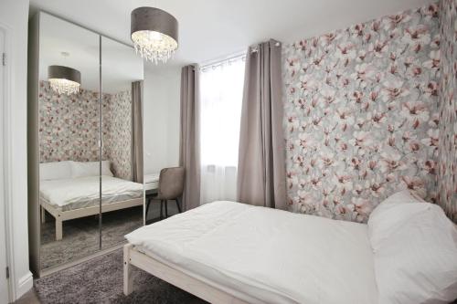 a bedroom with a bed and a mirror at APod in Coventry