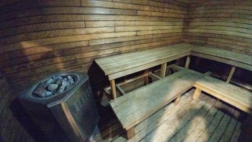 an inside of a wooden sauna with a trash can at Argyll Plaza Hotel in Edmonton