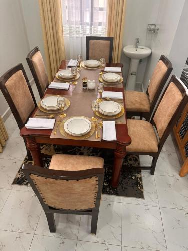 a dining room table with chairs and a dining room at Nalim bliss garden in Ruiru