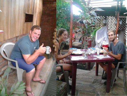 a group of people sitting at a table at Hostel Julieta in Rivas