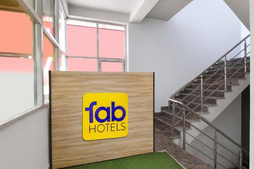 a sign for the toro hotels is next to a staircase at FabHotel Palak Palace in Jaipur