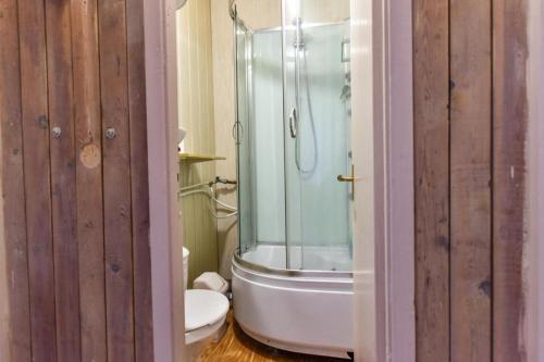 a bathroom with a glass shower and a toilet at Private double room with balcony in Neringa