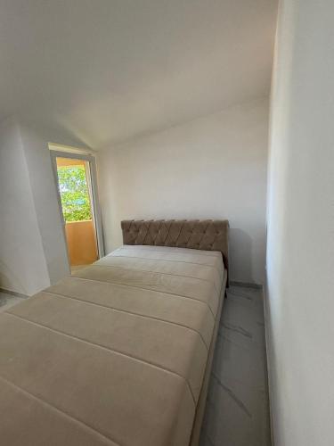a small bedroom with a bed in the corner at Beachside Apartments Novalja in Stara Novalja