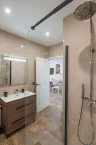 a bathroom with a sink and a glass shower at El Prado, 2 in El Mármol