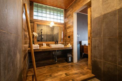 a bathroom with a sink and a mirror at Wanagiri Reserve in Gitgit