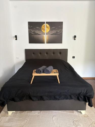 a bedroom with a bed with two towels on it at La Luna Apartman in Bečej