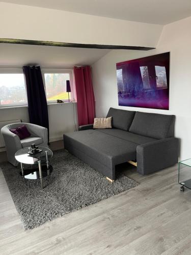 a living room with a couch and a chair at Ferienwohnung Amselnest in Seeboden