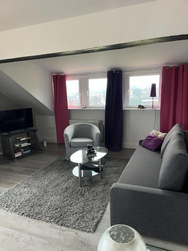 a living room with a couch and a table at Ferienwohnung Amselnest in Seeboden