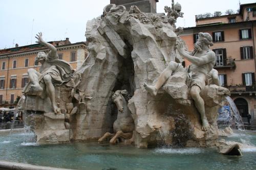 a statue of two men on a fountain at Vicolo Vecchio 59 in Rome